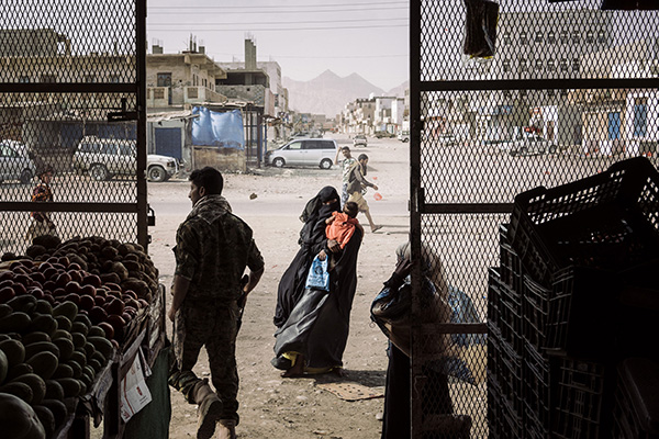 AZZAN, YEMEN - MAY 22nd, 2018:A veiled woman begs outside a grocery store in the village of Azzan.The village of Azzan was under the control of Al-Qaeda until the Shabwani elite forces liberated the area in December 2017. This armed group is aligned with a coalition led by Saudi Arabia and the UAE and is operating in the area in the fight against Al-Qaeda.Over the past year, the shadow war between al-Qaeda and local Yemeni fighters has intensified, largely out of sight and out of the headlines. While much attention has been paid to a separate Yemeni civil war pitting northern rebels against the internationally recognised government, the battle being waged by U.S.-backed Yemeni forces against al-Qaeda militants has escalated.But while the militants have been expelled from some of their strongholds, Yemeni fighters combating the group in the hinterlands of Shabwa and Abyan provinces acknowledge that their recent gains against al-Qaeda are precarious.Photo by Lorenzo Tugnoli/ The Washington Post/ Contrasto